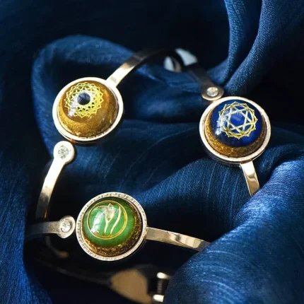Collection of orgone energy bracelets featuring golden, green, and blue designs with sacred geometry art , promoting vitality, prosperity, and health.