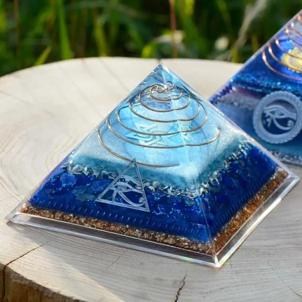 Orgonite crystal pyramid with Lapis Lazuli and orgone energy for spiritual clarity and chakra alignment.